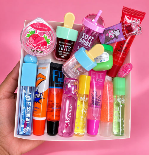 15-piece lip gloss and lip care bundle in a tray against a pink background